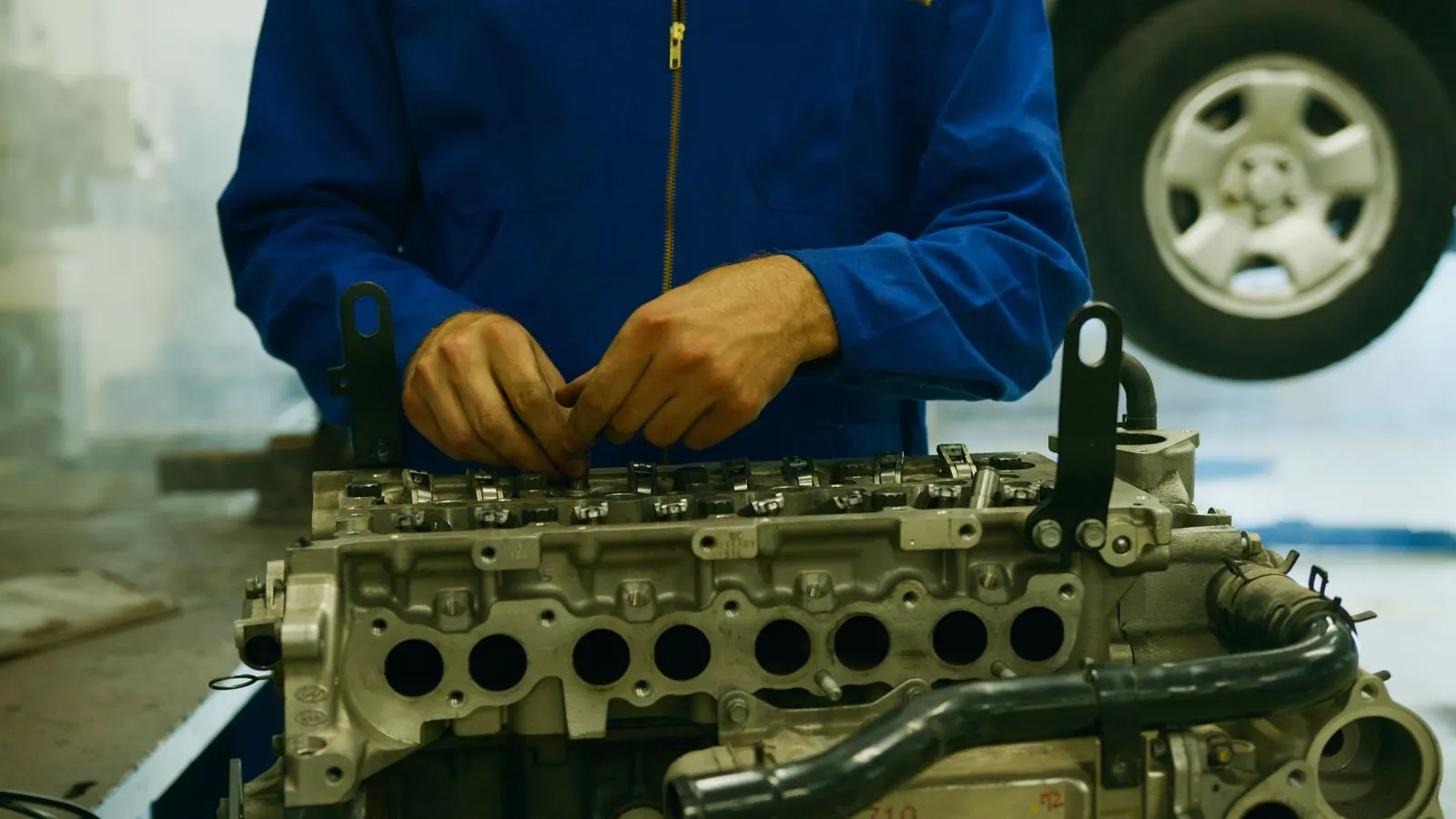 Technician working on a disassembled engine